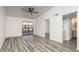 Bright living room with sliding glass doors, ceiling fan and wood-look floors at 1351 N Pleasant Dr # 2011, Chandler, AZ 85225