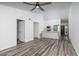 Open concept living room and kitchen with ceiling fan and wood-look flooring at 1351 N Pleasant Dr # 2011, Chandler, AZ 85225