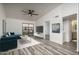 Sunlit living area boasts vaulted ceilings, a ceiling fan, and access to a private balcony at 1351 N Pleasant Dr # 2011, Chandler, AZ 85225
