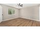 Bedroom with hardwood floors, a ceiling fan, and a view of trees at 13805 N 31St Ave, Phoenix, AZ 85053
