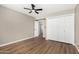 Cozy bedroom with a fan, closet, and wood-look flooring at 13805 N 31St Ave, Phoenix, AZ 85053