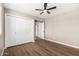 Bright bedroom with a fan, closet, and wood-look flooring at 13805 N 31St Ave, Phoenix, AZ 85053