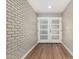 Bright entryway with modern flooring, painted brick wall, and white double doors with glass panels at 13805 N 31St Ave, Phoenix, AZ 85053