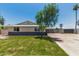 Charming single-story home with a well-manicured lawn, inviting curb appeal, and a long driveway at 13805 N 31St Ave, Phoenix, AZ 85053