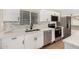 Renovated kitchen featuring stainless appliances, bright white cabinets, and modern fixtures at 13805 N 31St Ave, Phoenix, AZ 85053