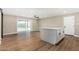 Living room with an island into the kitchen, with backyard sports court view and a door to the garage at 13805 N 31St Ave, Phoenix, AZ 85053