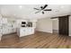 Open-concept living space adjacent to a modern kitchen with white cabinets and updated appliances at 13805 N 31St Ave, Phoenix, AZ 85053