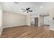Open living space boasts modern flooring, a ceiling fan, and view into the kitchen and entry at 13805 N 31St Ave, Phoenix, AZ 85053