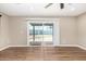 Living room featuring wood-look flooring and sliding glass door with access to backyard sports court at 13805 N 31St Ave, Phoenix, AZ 85053