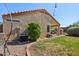 Exterior view of the home highlighting the desert landscaping and backyard patio at 14822 N Tonya Cir, El Mirage, AZ 85335