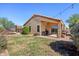 Spacious backyard featuring green grass, a trampoline, and patio furniture at 14822 N Tonya Cir, El Mirage, AZ 85335