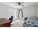 Bedroom featuring carpet floors, a ceiling fan, a large window, and a closet with sliding doors at 14822 N Tonya Cir, El Mirage, AZ 85335