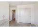 Simple bedroom with neutral walls, open and closet doors, and woven furniture at 14822 N Tonya Cir, El Mirage, AZ 85335