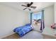 Bright bedroom with a ceiling fan and window view of the neighborhood at 14822 N Tonya Cir, El Mirage, AZ 85335