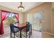 Bright dining area featuring a wood table, large windows, and backyard access for easy outdoor dining at 14822 N Tonya Cir, El Mirage, AZ 85335