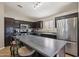 Modern kitchen featuring dark cabinetry, stainless steel appliances, and a large island at 14822 N Tonya Cir, El Mirage, AZ 85335