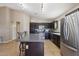 Bright kitchen with dark cabinets, stainless appliances, and a large kitchen island at 14822 N Tonya Cir, El Mirage, AZ 85335