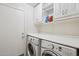 Laundry room featuring front loading washer and dryer set with white cabinets at 14822 N Tonya Cir, El Mirage, AZ 85335