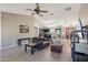 Comfortable living room with tile flooring, ceiling fan, and view into the kitchen and dining area at 14822 N Tonya Cir, El Mirage, AZ 85335