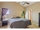 Spacious main bedroom featuring neutral tones, a large window, and easy access to the ensuite bathroom at 14822 N Tonya Cir, El Mirage, AZ 85335