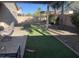 Serene backyard with artificial turf, desert landscape, a shade structure and a patio at 178 W Pacific Dr, Casa Grande, AZ 85122