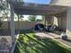 Outdoor patio with string lights, grill, and dining set in a relaxing backyard at 178 W Pacific Dr, Casa Grande, AZ 85122