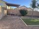 Private backyard featuring a patio, artificial turf, and a desert-friendly landscape with a shade structure at 178 W Pacific Dr, Casa Grande, AZ 85122