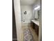 Inviting bathroom featuring a soaking tub, custom vanity, and granite counters at 178 W Pacific Dr, Casa Grande, AZ 85122