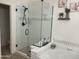 Bathroom showcasing a tiled shower with glass enclosure and a soaking tub, and decorative shelving at 178 W Pacific Dr, Casa Grande, AZ 85122