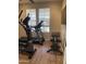 Functional exercise room with treadmill, elliptical, bench and weights; large window provides natural light at 178 W Pacific Dr, Casa Grande, AZ 85122