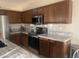 Well-equipped kitchen featuring granite countertops, stainless steel appliances, and rich cabinetry at 178 W Pacific Dr, Casa Grande, AZ 85122
