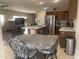 Open kitchen features stainless appliances, granite counters, and an island with breakfast bar, great for entertaining at 178 W Pacific Dr, Casa Grande, AZ 85122