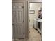 Convenient laundry room with modern washer and dryer, shelving, and tiled floors, providing functionality at 178 W Pacific Dr, Casa Grande, AZ 85122