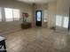 Bright living room featuring tile floors and a decorative front door at 178 W Pacific Dr, Casa Grande, AZ 85122