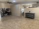 Open-concept living room with tile floors flowing into adjacent kitchen and dining areas at 178 W Pacific Dr, Casa Grande, AZ 85122