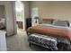 Comfortable main bedroom with large window, neutral colors, and an ensuite bathroom at 178 W Pacific Dr, Casa Grande, AZ 85122