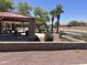 Community park with covered picnic area, palm trees and green spaces for residents at 178 W Pacific Dr, Casa Grande, AZ 85122