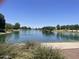 A large pond with a fountain is surrounded by trees and walking paths for residents at 178 W Pacific Dr, Casa Grande, AZ 85122