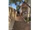 View of the side yard with decorative items, gravel, and a tan privacy wall at 178 W Pacific Dr, Casa Grande, AZ 85122