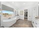 Bright bathroom with a soaking tub, double vanity, and large window at 1785 W Brooke Ln, Queen Creek, AZ 85144