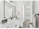 Beautiful bathroom featuring double sinks, black hardware, and a view into another bathroom at 1785 W Brooke Ln, Queen Creek, AZ 85144