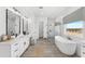 An elegant bathroom with a soaking tub, walk-in shower, and double vanity at 1785 W Brooke Ln, Queen Creek, AZ 85144