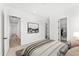 A bright bedroom features neutral walls and carpet, a modern ceiling fan and an ensuite bathroom and closet at 1785 W Brooke Ln, Queen Creek, AZ 85144