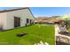 The large backyard has green grass, patio furniture, and a pool with mountain views at 1809 E Gwen St, Phoenix, AZ 85042
