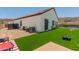 Backyard view featuring a large green lawn, mountain views, and outdoor seating at 1809 E Gwen St, Phoenix, AZ 85042