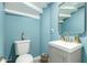 Stylish powder room featuring blue walls, a modern vanity, and elegant fixtures, plus tile floors at 1809 E Gwen St, Phoenix, AZ 85042
