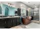Primary bathroom featuring dual vanities, a luxurious copper soaking tub, and elegant fixtures at 1809 E Gwen St, Phoenix, AZ 85042