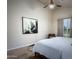 Bright bedroom featuring light-colored walls, hardwood floors, and a ceiling fan at 1809 E Gwen St, Phoenix, AZ 85042