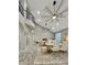 Open-concept living and dining area showcasing high ceilings, wrought iron balcony, and cohesive, modern design at 1809 E Gwen St, Phoenix, AZ 85042
