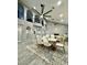 Stylish dining area with modern lighting, adjacent to a grand living space and wrought iron staircase at 1809 E Gwen St, Phoenix, AZ 85042
